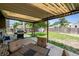 Covered patio and grill in a well-maintained backyard with green grass at 4502 S Gar Way, Littleton, CO 80123
