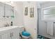 Clean bathroom with a white vanity, toilet with blue seat, and shower at 4502 S Gar Way, Littleton, CO 80123
