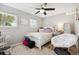 Well-lit bedroom with two windows, a ceiling fan, and stylish decor at 4502 S Gar Way, Littleton, CO 80123