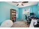 Bright bedroom features a ceiling fan, gray carpeting, and built-in bookshelf at 4502 S Gar Way, Littleton, CO 80123