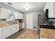 Functional kitchen featuring white cabinets, stainless steel appliances, and neutral countertops at 4502 S Gar Way, Littleton, CO 80123