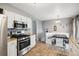 Spacious kitchen featuring stainless steel appliances and a cozy breakfast nook with a black table at 4502 S Gar Way, Littleton, CO 80123