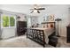 Spacious main bedroom with a large bed, dark wood furniture, and neutral-toned walls at 4502 S Gar Way, Littleton, CO 80123
