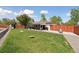 Expansive backyard with lush green grass and a covered patio, perfect for outdoor entertaining at 45 S Reed St, Lakewood, CO 80226