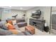 A finished basement with an entertainment area, comfortable seating, a TV, and workout equipment offering a cozy retreat at 45 S Reed St, Lakewood, CO 80226