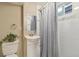 Bathroom with white subway tile, new vanity, decorative mirror and natural light from window at 45 S Reed St, Lakewood, CO 80226
