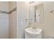 Bright bathroom featuring tiled walls, modern sink, and sleek fixtures, offering a clean and updated design at 45 S Reed St, Lakewood, CO 80226