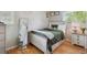 Cozy bedroom with a full sized bed, wood floors, large window and decorative pillows creating an inviting space at 45 S Reed St, Lakewood, CO 80226