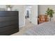 Comfortable bedroom featuring a black dresser, plants, and doorway adding warmth and style at 45 S Reed St, Lakewood, CO 80226