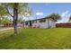 Attractive home featuring a well-groomed lawn and a cozy front porch with seating at 45 S Reed St, Lakewood, CO 80226