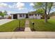 Beautiful home with a well-maintained lawn and a walkway leading to the inviting front entrance at 45 S Reed St, Lakewood, CO 80226