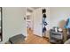 Hallway features a wood floor, an opened door to a bedroom, and decorative touches creating an inviting space at 45 S Reed St, Lakewood, CO 80226