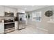 Bright kitchen features stainless steel appliances, tile flooring, and a window view at 45 S Reed St, Lakewood, CO 80226