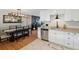 Open-concept kitchen and dining area with stainless steel appliances and stylish finishes at 45 S Reed St, Lakewood, CO 80226