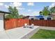 Private patio area with modern chairs and a view of the fenced yard at 45 S Reed St, Lakewood, CO 80226