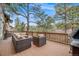 Back deck boasts plenty of lounge seating, a grill, and relaxing views of the property at 1221 Havenwood Way, Castle Pines, CO 80108