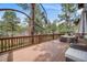 Relaxing back deck features outdoor seating, grill, and views of the surrounding trees and landscape at 1221 Havenwood Way, Castle Pines, CO 80108