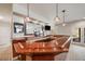 Basement bar area with wooden countertop, pendant lights, and large mirror at 1221 Havenwood Way, Castle Pines, CO 80108