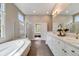 Bright primary bath with double sinks, soaking tub, and shower at 1221 Havenwood Way, Castle Pines, CO 80108