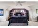 Bedroom with purple accent wall, three windows, shelving, and a ceiling fan at 1221 Havenwood Way, Castle Pines, CO 80108