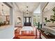 Elegant foyer with gleaming hardwood floors, chandelier, and views into the dining room at 1221 Havenwood Way, Castle Pines, CO 80108