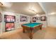 Spacious game room with a billiard table and display cases featuring sports memorabilia at 1221 Havenwood Way, Castle Pines, CO 80108