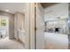 Hallway leading to bright bedroom with decoratively decorated walls and comfortable sitting area at 1221 Havenwood Way, Castle Pines, CO 80108