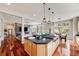 Open kitchen with granite countertops, stainless steel appliances, and a large island with bar seating at 1221 Havenwood Way, Castle Pines, CO 80108