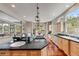 Spacious kitchen featuring wood floors, granite countertops, stainless steel appliances, and ample natural light at 1221 Havenwood Way, Castle Pines, CO 80108