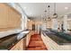 Bright, open kitchen with granite counters, stainless steel appliances, and hardwood floors at 1221 Havenwood Way, Castle Pines, CO 80108