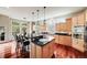 Spacious kitchen with wooden cabinets, granite countertops, a central island, and stainless steel appliances at 1221 Havenwood Way, Castle Pines, CO 80108