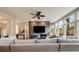 Open-concept living room features a fireplace and large windows for natural light and outdoor views at 1221 Havenwood Way, Castle Pines, CO 80108