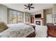 Relaxing primary bedroom with large windows, fireplace and private deck at 1221 Havenwood Way, Castle Pines, CO 80108