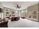 Bright primary bedroom with large windows, ceiling fan, and a private balcony overlooking the natural setting at 1221 Havenwood Way, Castle Pines, CO 80108