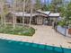 Home features a pool house and a gated pool with a pool cover. Mature trees at 1221 Havenwood Way, Castle Pines, CO 80108