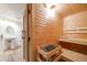 Interior view of sauna with wooden benches next to a bathroom with a sink at 1221 Havenwood Way, Castle Pines, CO 80108