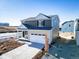 Two-story home with a two car garage and neutral colored landscaping at 3869 N Shawee St, Aurora, CO 80019