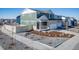 New two-story home with a front yard, sidewalk, and driveway at 3869 N Shawee St, Aurora, CO 80019