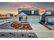 Two-story home with a two car garage and neutral colored landscaping at sunset at 3869 N Shawee St, Aurora, CO 80019