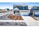 Two-story home with a two car garage and neutral colored landscaping at 3869 N Shawee St, Aurora, CO 80019