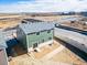 Exterior view of home showcasing green siding and a well-defined backyard space at 3869 N Shawee St, Aurora, CO 80019
