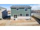 Exterior back view of home featuring green siding and a sliding glass door at 3869 N Shawee St, Aurora, CO 80019