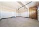 Clean, spacious garage with a concrete floor, drywall walls, and an overhead door at 3869 N Shawee St, Aurora, CO 80019