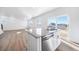 Modern kitchen with island, stainless steel appliances, and wood floors at 3869 N Shawee St, Aurora, CO 80019
