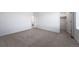 A serene bedroom with gray carpet and access to a bathroom and a walk-in closet at 3869 N Shawee St, Aurora, CO 80019