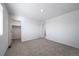 Bright bedroom with plush gray carpet, closet, and bathroom entrance at 3869 N Shawee St, Aurora, CO 80019