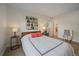 Light-filled bedroom features hardwood flooring, bright windows and ensuite bathroom at 8335 Fairmount Dr # 2-105, Denver, CO 80247