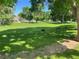 Spacious green space with mature trees and seating at 8335 Fairmount Dr # 2-105, Denver, CO 80247