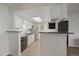 Bright kitchen features stainless appliances, subway tile backsplash, and a breakfast bar for casual dining at 8335 Fairmount Dr # 2-105, Denver, CO 80247