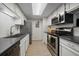 Well-lit kitchen featuring stainless appliances, white cabinets, and sleek countertops for a modern look at 8335 Fairmount Dr # 2-105, Denver, CO 80247